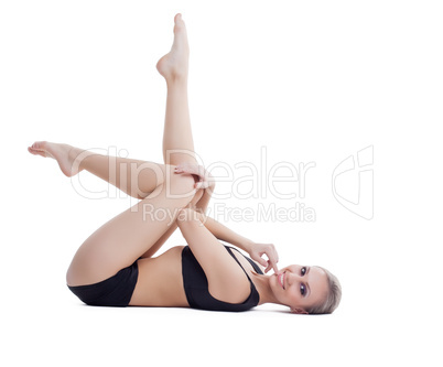 Studio shot of smiling beautiful fitness trainer