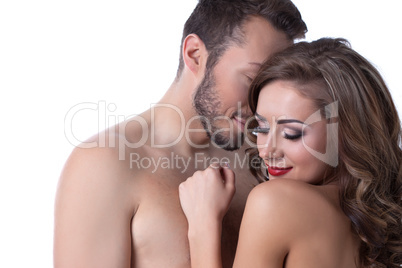 Sexy naked girl shyly hiding in arms of lover