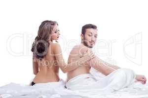 Pair of beautiful young lovers posing in bed