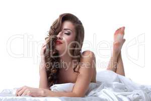 Charming excited woman posing while lying in bed