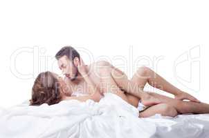 Flushed lovers posing in bed, isolated on white