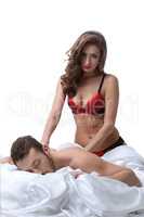 Domineering young woman doing massage to her lover