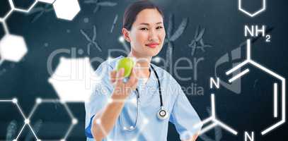 Composite image of smiling surgeon holding an apple with colleag