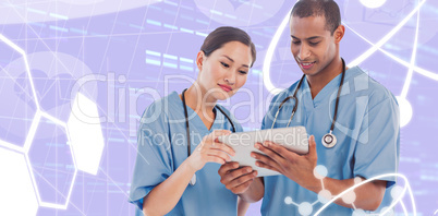 Composite image of surgeons looking at digital tablet in hospita