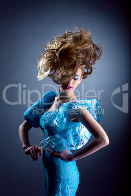 Creative model posing in blue dress