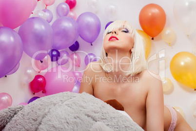 Shot of passionate topless blonde posing in studio