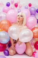Sexy platinum blonde posing with balloons
