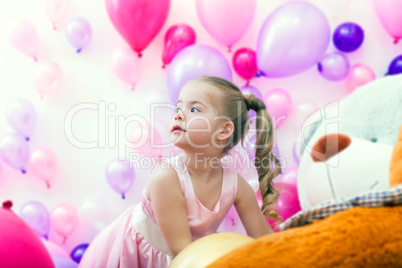 Pretty little lady posing on balloons backdrop