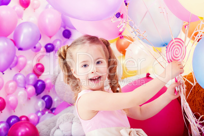 Merry little girl posing with bunch of balloons