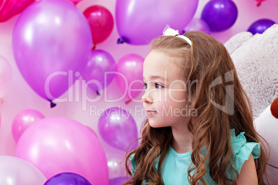 Beautiful little girl on background of balloons