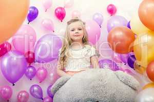 Lovely young lady posing with colorful balloons