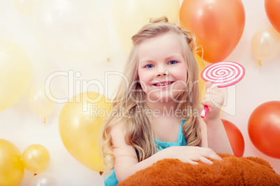 Portrait of funny little model with lollipop