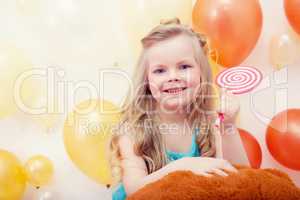 Portrait of funny little model with lollipop