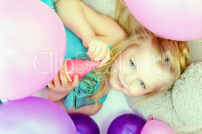 Smiling cute young girl posing at camera, close-up