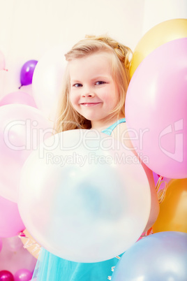 Funny little girl posing with balloons
