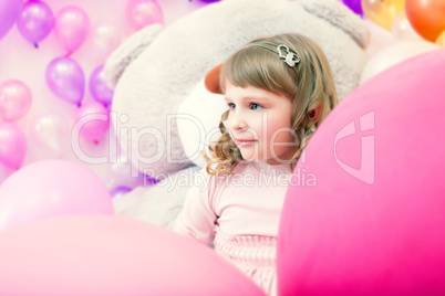 Portrait of lovely little girl posing in playroom