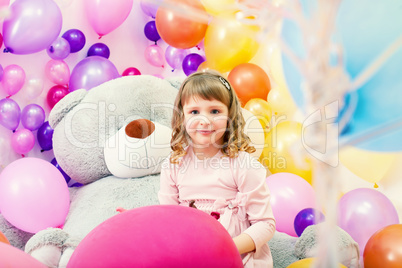 Smiling little girl posing in playroom