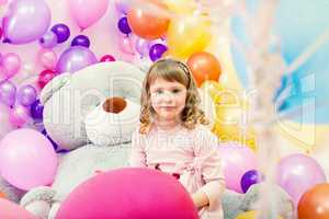 Smiling little girl posing in playroom