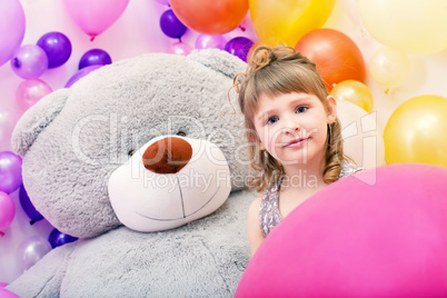 Portrait of blue-eyed girl with big teddy bear