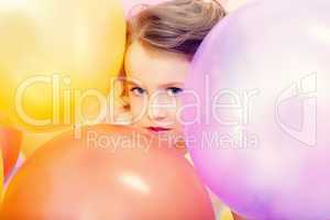 Cute girl posing with balloons, close-up