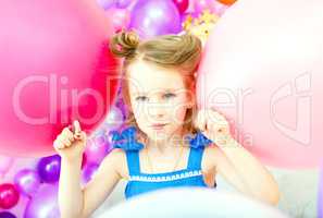 Funny little girl posing with colorful balloons