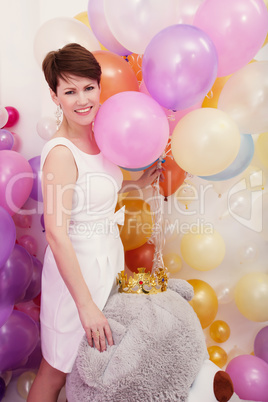 Charming woman posing with bunch of balloons