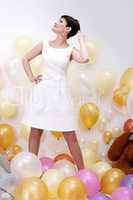 Stylish woman posing with balloons in studio