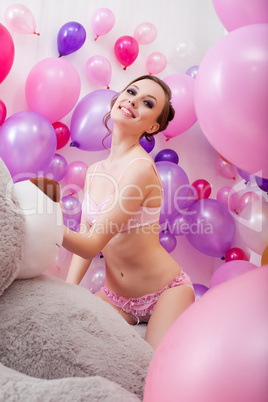 Lovely young woman posing with balloons