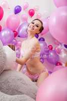 Lovely young woman posing with balloons