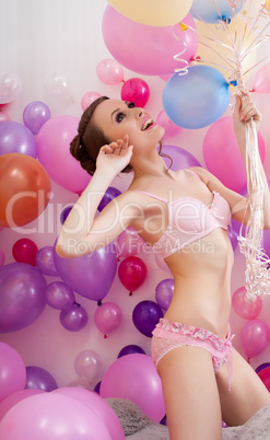 Sexy slim model posing in lingerie with balloons