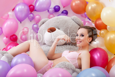Smiling beautiful model posing with plush bear
