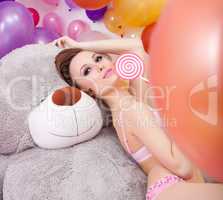 Image of beddable woman posing with lollipop