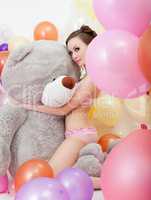 Image of sexy slim woman hugging big teddy bear