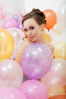 Attractive nude girl posing with colorful balloons