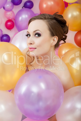 Portrait of flirty brunette posing with balloons