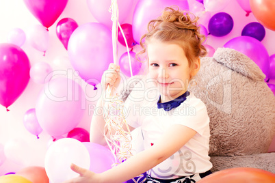 Portrait of smiling girl on balloons background