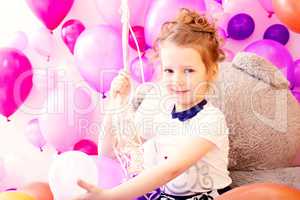 Portrait of smiling girl on balloons background