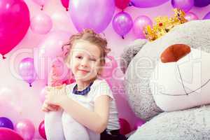 Smiling girl posing with ice cream in playroom