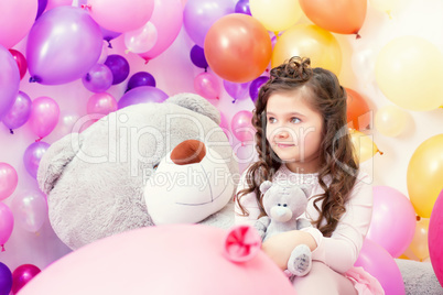 Lovely dark-haired girl posing with teddy bears