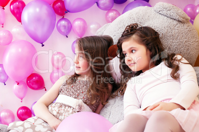 Image of elegant girlfriends posing in playroom