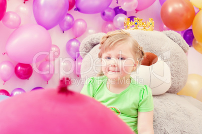 Amusing blonde girl posing in playroom