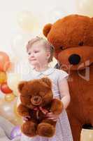 Funny blonde girl posing with teddy bears