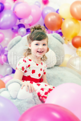 Image of merry little girl posing in playroom