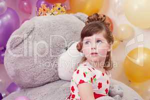 Dreamy girl posing on backdrop of teddy bear