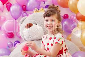 Image of joyful little girl posing in playroom