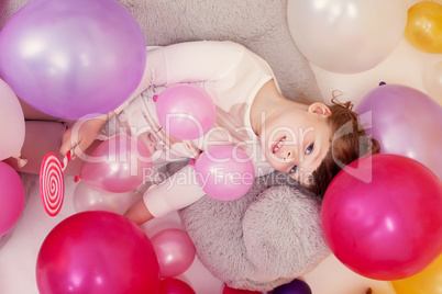 Top view of charming little lady with lollipop