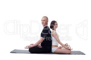 European couple doing yoga in studio