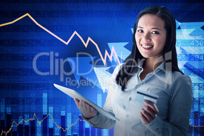 Composite image of smiling businesswoman holding laptop and cred