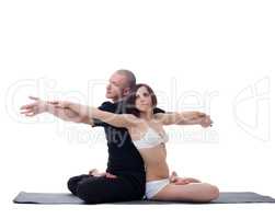 Muscular man and skinny girl practicing yoga