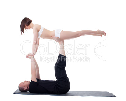 Couple of yoga trainers practising in studio
